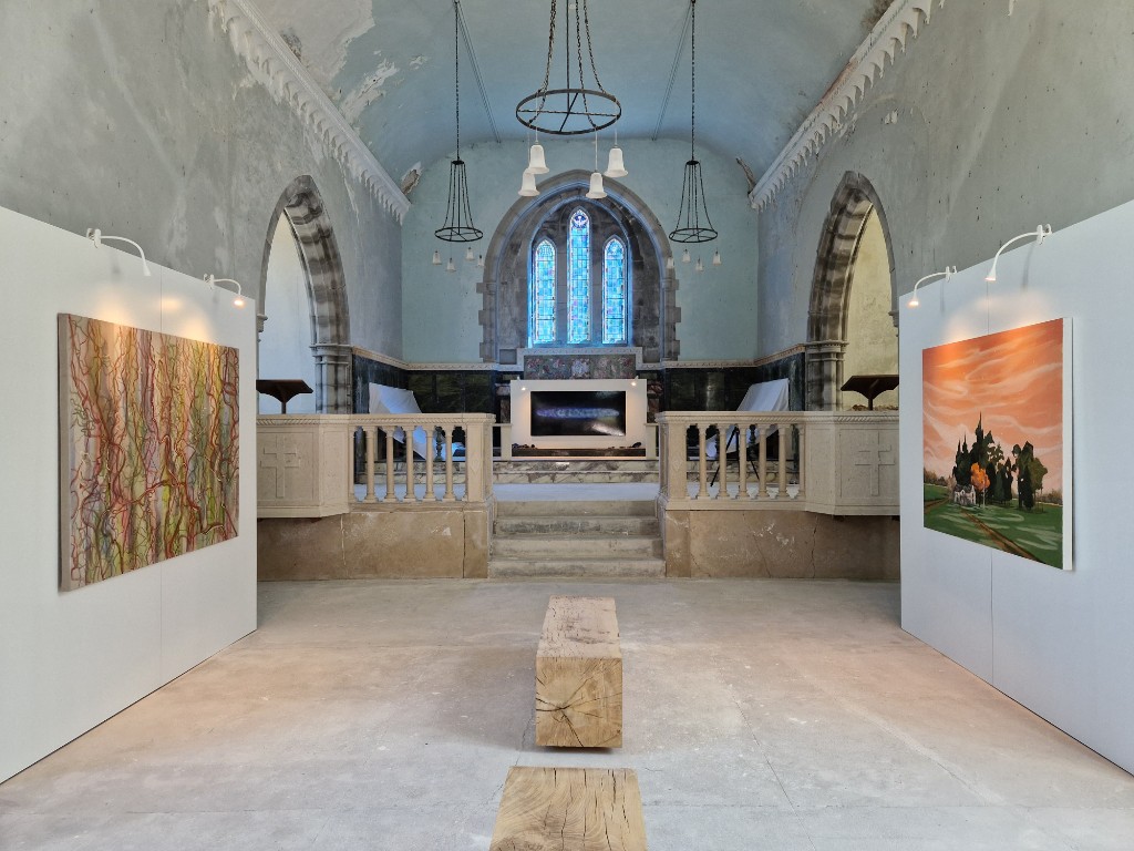 Exhibition installation in a chapel with large-scale paintings.